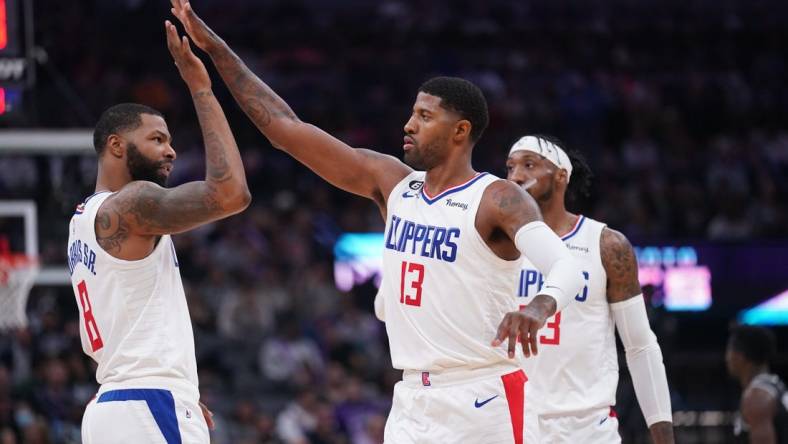 Oct 22, 2022; Sacramento, California, USA; Los Angeles Clippers forward Paul George (13) is congratulated by forward Marcus Morris Sr. (8) after making a three point shot against the Sacramento Kings in the second quarter at the Golden 1 Center. Mandatory Credit: Cary Edmondson-USA TODAY Sports