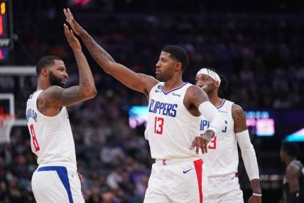 Oct 22, 2022; Sacramento, California, USA; Los Angeles Clippers forward Paul George (13) is congratulated by forward Marcus Morris Sr. (8) after making a three point shot against the Sacramento Kings in the second quarter at the Golden 1 Center. Mandatory Credit: Cary Edmondson-USA TODAY Sports