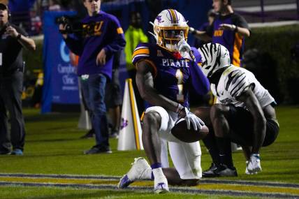 Oct 15, 2022; Greenville, North Carolina, USA;  East Carolina Pirates cornerback Malik Fleming (1) celebrates breaking up a pass attempt against the Memphis Tigers during the second half at Dowdy-Ficklen Stadium. Mandatory Credit: James Guillory-USA TODAY Sports