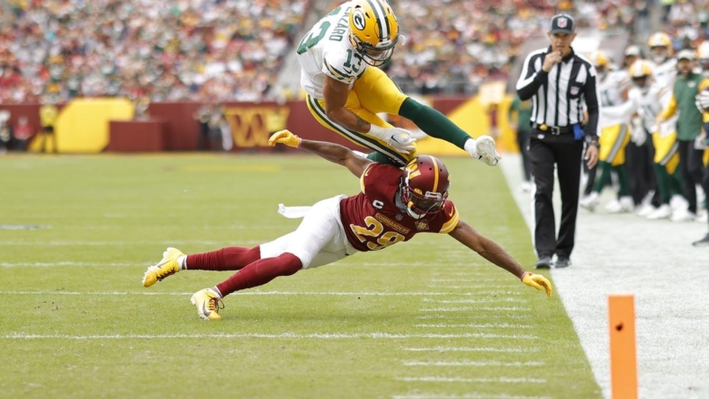 Oct 23, 2022; Landover, Maryland, USA; Green Bay Packers wide receiver Allen Lazard (13) leaps over Washington Commanders cornerback Kendall Fuller (29) while attempting to score a touchdown during the first quarter at FedExField. Mandatory Credit: Geoff Burke-USA TODAY Sports