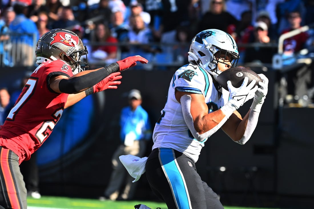 Oct 23, 2022; Charlotte, North Carolina, USA; Carolina Panthers tight end Tommy Tremble (82) catches a touchdown as Tampa Bay Buccaneers cornerback Zyon McCollum (27) defends in the fourth quarter at Bank of America Stadium. Mandatory Credit: Bob Donnan-USA TODAY Sports