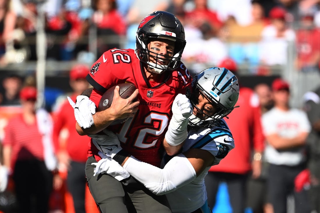 Oct 23, 2022; Charlotte, North Carolina, USA; Tampa Bay Buccaneers quarterback Tom Brady (12) is tackled by Carolina Panthers linebacker Frankie Luvu (49) in the third quarter at Bank of America Stadium. Mandatory Credit: Bob Donnan-USA TODAY Sports