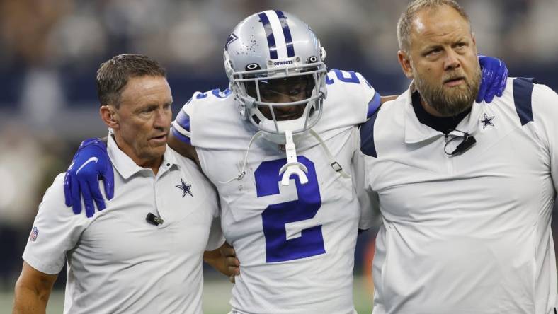 Oct 23, 2022; Arlington, Texas, USA; Dallas Cowboys cornerback Jourdan Lewis (2) is helped off the field by medical staff members in the fourth quarter against the Detroit Lions at AT&T Stadium. Mandatory Credit: Tim Heitman-USA TODAY Sports