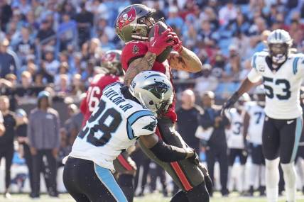 Oct 23, 2022; Charlotte, North Carolina, USA; Tampa Bay Buccaneers wide receiver Mike Evans (13) is hit as he makes a catch by Carolina Panthers cornerback Keith Taylor Jr. (28) during the second half at Bank of America Stadium. Mandatory Credit: Jim Dedmon-USA TODAY Sports