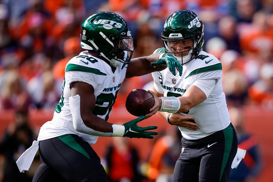Oct 23, 2022; Denver, Colorado, USA; New York Jets quarterback Zach Wilson (2) hands the ball off to running back Breece Hall (20) in the first quarter against the Denver Broncos at Empower Field at Mile High. Mandatory Credit: Isaiah J. Downing-USA TODAY Sports