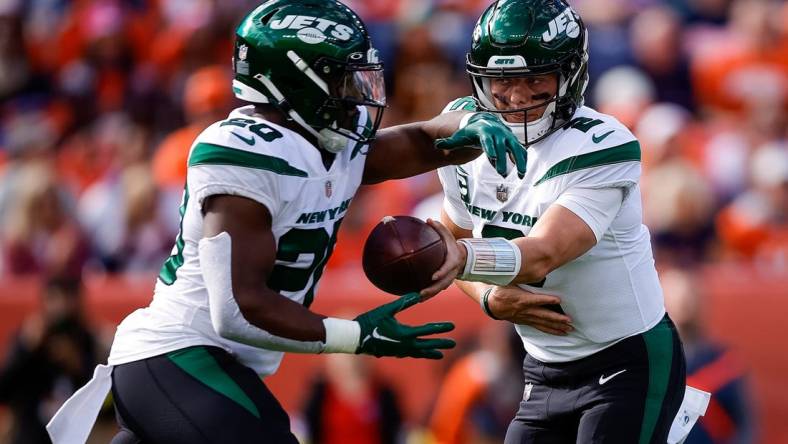 Oct 23, 2022; Denver, Colorado, USA; New York Jets quarterback Zach Wilson (2) hands the ball off to running back Breece Hall (20) in the first quarter against the Denver Broncos at Empower Field at Mile High. Mandatory Credit: Isaiah J. Downing-USA TODAY Sports