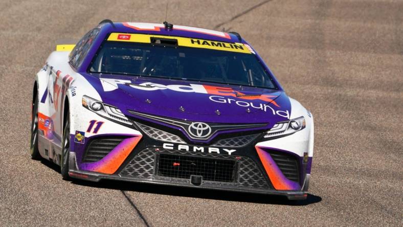 Oct 23, 2022; Homestead, Florida, USA; NASCAR Cup Series driver Denny Hamlin (11) races into turn one during the Dixie Vodka 400 at Homestead-Miami Speedway. Mandatory Credit: John David Mercer-USA TODAY Sports