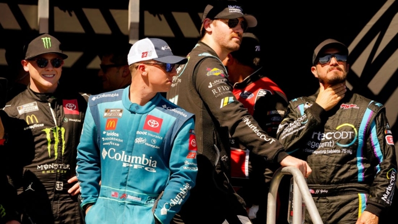 Oct 23, 2022; Homestead, Florida, USA; NASCAR Cup Series driver Ty Gibbs (23)  driver John Hunter Nemecheck (45) , driver Cody Ware (51) and driver JJ Yeley (15) wait for driver introductions before the Dixie Vodka 400 at Homestead-Miami Speedway. Mandatory Credit: John David Mercer-USA TODAY Sports