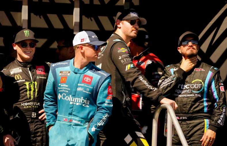 Oct 23, 2022; Homestead, Florida, USA; NASCAR Cup Series driver Ty Gibbs (23)  driver John Hunter Nemecheck (45) , driver Cody Ware (51) and driver JJ Yeley (15) wait for driver introductions before the Dixie Vodka 400 at Homestead-Miami Speedway. Mandatory Credit: John David Mercer-USA TODAY Sports