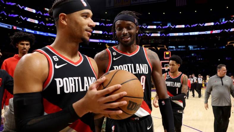 Oct 23, 2022; Los Angeles, California, USA;  Portland Trail Blazers guard Josh Hart (11) and forward Jerami Grant (9) celebrate a victory against the Los Angeles Lakers at Crypto.com Arena. Mandatory Credit: Kiyoshi Mio-USA TODAY Sports