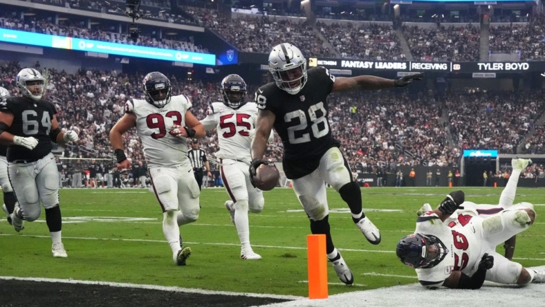 Oct 23, 2022; Paradise, Nevada, USA; Las Vegas Raiders running back Josh Jacobs (28) scores on a 7-yard touchdown run in the third quarter against the Houston Texans at Allegiant Stadium. Mandatory Credit: Kirby Lee-USA TODAY Sports