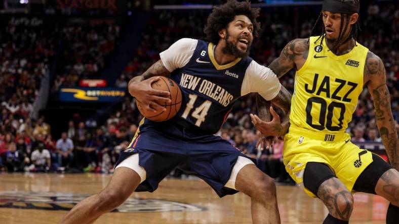 Oct 23, 2022; New Orleans, Louisiana, USA; New Orleans Pelicans forward Brandon Ingram (14) dribbles against Utah Jazz guard Jordan Clarkson (00) during the first half at Smoothie King Center. Mandatory Credit: Stephen Lew-USA TODAY Sports