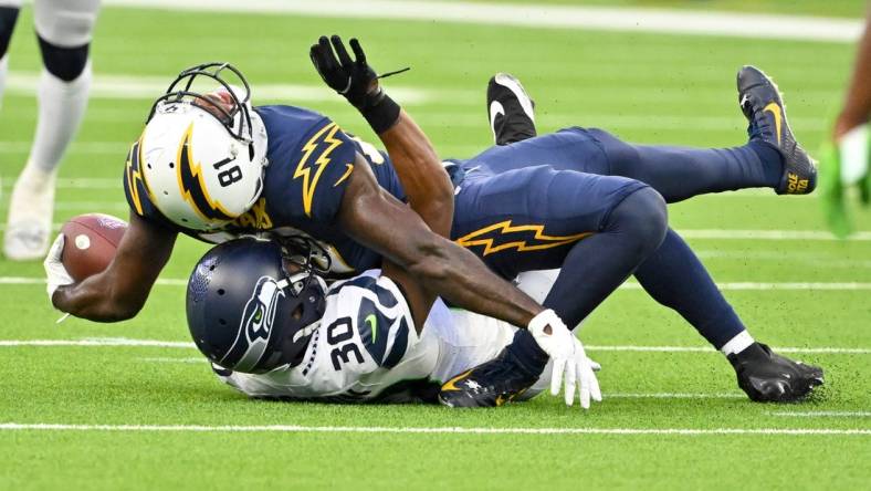 Oct 23, 2022; Inglewood, California, USA;  Los Angeles Chargers wide receiver Mike Williams (81) injured his ankle after he is brought down by Seattle Seahawks cornerback Mike Jackson (30) after a complete pass in the second half at SoFi Stadium. Mandatory Credit: Jayne Kamin-Oncea-USA TODAY Sports