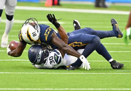 Oct 23, 2022; Inglewood, California, USA;  Los Angeles Chargers wide receiver Mike Williams (81) injured his ankle after he is brought down by Seattle Seahawks cornerback Mike Jackson (30) after a complete pass in the second half at SoFi Stadium. Mandatory Credit: Jayne Kamin-Oncea-USA TODAY Sports