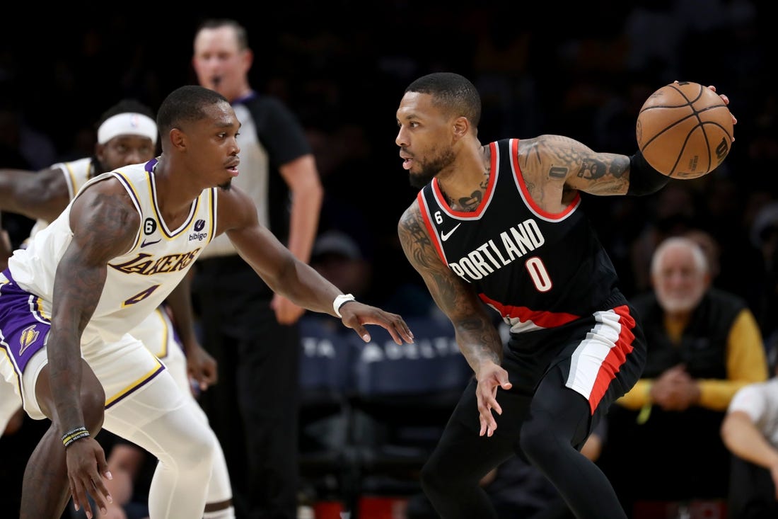 Oct 23, 2022; Los Angeles, California, USA;  Portland Trail Blazers guard Damian Lillard (0) dribbles the ball against Los Angeles Lakers guard Lonnie Walker IV (4) during the second half at Crypto.com Arena. Mandatory Credit: Kiyoshi Mio-USA TODAY Sports