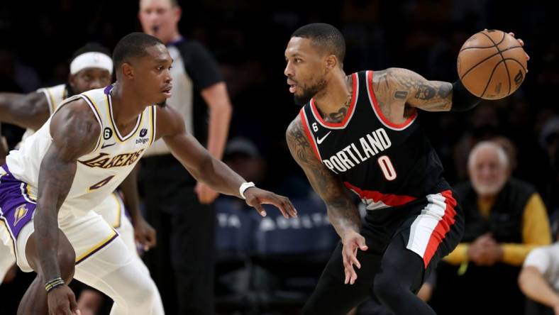 Oct 23, 2022; Los Angeles, California, USA;  Portland Trail Blazers guard Damian Lillard (0) dribbles the ball against Los Angeles Lakers guard Lonnie Walker IV (4) during the second half at Crypto.com Arena. Mandatory Credit: Kiyoshi Mio-USA TODAY Sports