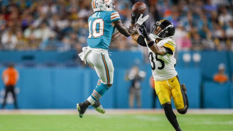 Oct 23, 2022; Miami Gardens, Florida, USA; Miami Dolphins wide receiver Tyreek Hill (10) catches the football over Pittsburgh Steelers cornerback Arthur Maulet (35) during the second quarter at Hard Rock Stadium. Mandatory Credit: Sam Navarro-USA TODAY Sports