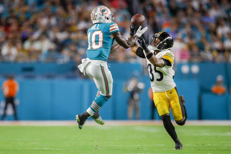 Oct 23, 2022; Miami Gardens, Florida, USA; Miami Dolphins wide receiver Tyreek Hill (10) catches the football over Pittsburgh Steelers cornerback Arthur Maulet (35) during the second quarter at Hard Rock Stadium. Mandatory Credit: Sam Navarro-USA TODAY Sports
