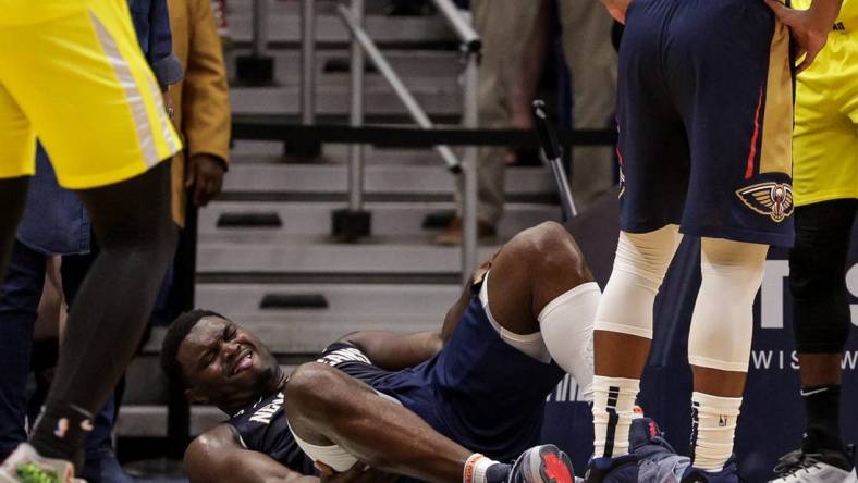 Oct 23, 2022; New Orleans, Louisiana, USA;  New Orleans Pelicans forward Zion Williamson (1) is injured on a play by a Utah Jazz player during the second half at Smoothie King Center. Mandatory Credit: Stephen Lew-USA TODAY Sports