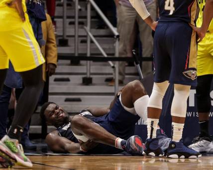 Oct 23, 2022; New Orleans, Louisiana, USA;  New Orleans Pelicans forward Zion Williamson (1) is injured on a play by a Utah Jazz player during the second half at Smoothie King Center. Mandatory Credit: Stephen Lew-USA TODAY Sports