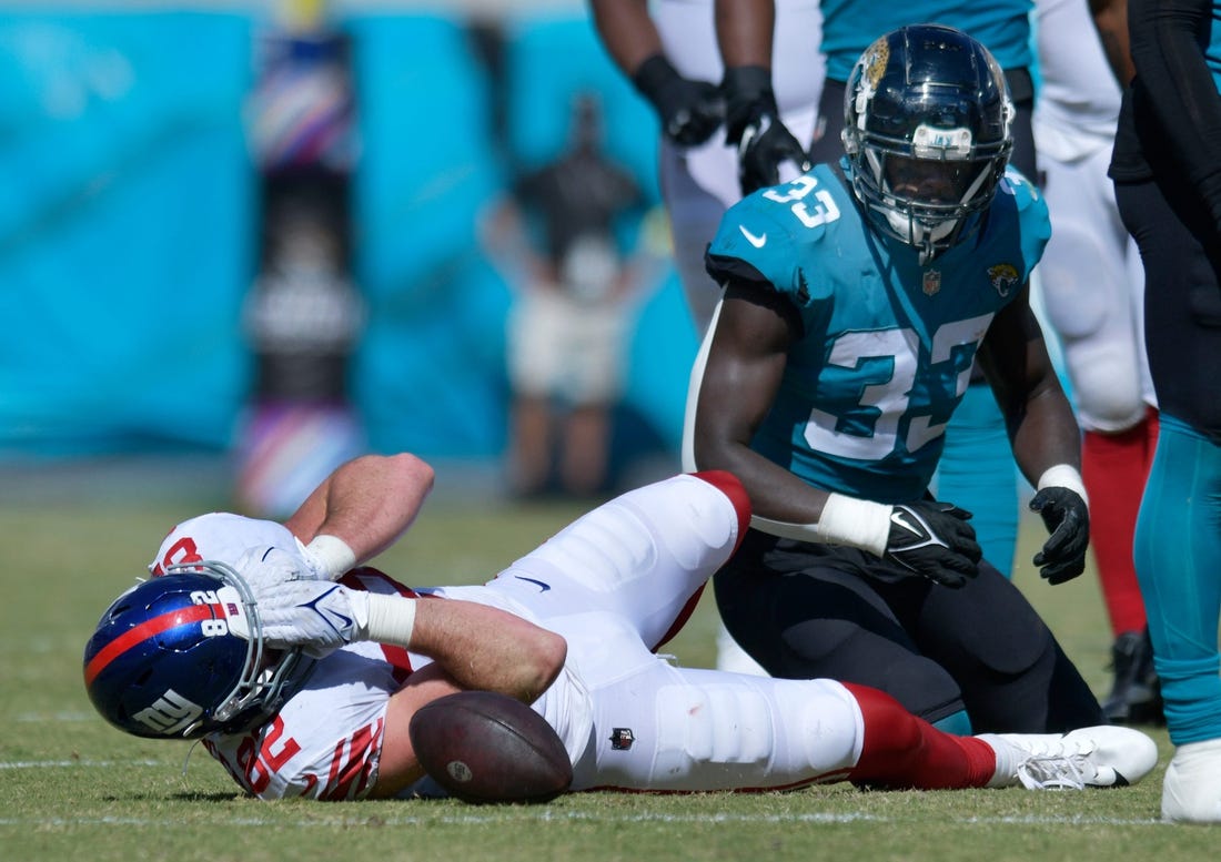 New York Giants tight end Daniel Bellinger (82) grabs his face after a tackle by Jacksonville Jaguars linebacker Devin Lloyd (33) which took Bellinger out of the game with an injury to his face late in the second quarter. The Jacksonville Jaguars hosted the New York Giants at TIAA Bank Field in Jacksonville, FL Sunday, October 23, 2022. The Jaguars trailed at the half 11 to 13. [Bob Self/Florida Times-Union]

Jki 102322 Hsfb Bs Jaguars Vs Giants 46