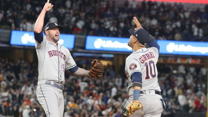 Oct 23, 2022; Bronx, New York, USA; Houston Astros relief pitcher Ryan Pressly (55) celebrates getting the final out of the game with first baseman Yuli Gurriel (10) in the ninth inning against the New York Yankees during game four of the ALCS for the 2022 MLB Playoffs at Yankee Stadium. Mandatory Credit: Brad Penner-USA TODAY Sports