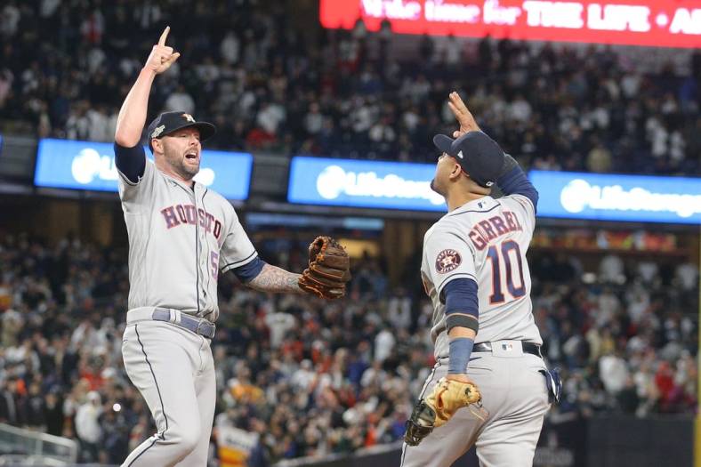 Oct 23, 2022; Bronx, New York, USA; Houston Astros relief pitcher Ryan Pressly (55) celebrates getting the final out of the game with first baseman Yuli Gurriel (10) in the ninth inning against the New York Yankees during game four of the ALCS for the 2022 MLB Playoffs at Yankee Stadium. Mandatory Credit: Brad Penner-USA TODAY Sports