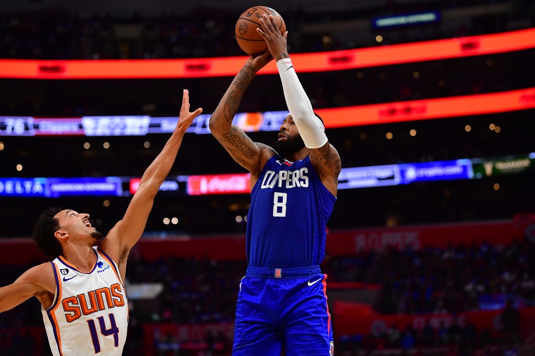 Oct 23, 2022; Los Angeles, California, USA; Los Angeles Clippers forward Marcus Morris Sr. (8) shoots against Phoenix Suns guard Landry Shamet (14) during the second half at Crypto.com Arena. Mandatory Credit: Gary A. Vasquez-USA TODAY Sports