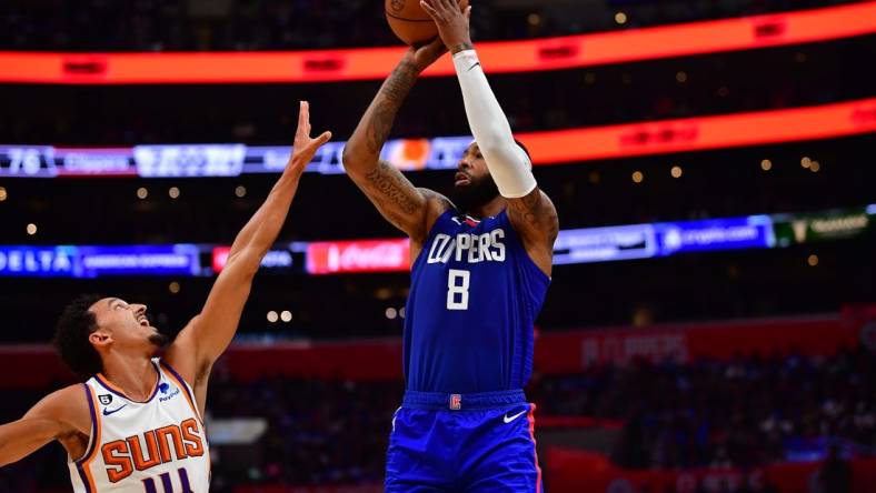 Oct 23, 2022; Los Angeles, California, USA; Los Angeles Clippers forward Marcus Morris Sr. (8) shoots against Phoenix Suns guard Landry Shamet (14) during the second half at Crypto.com Arena. Mandatory Credit: Gary A. Vasquez-USA TODAY Sports