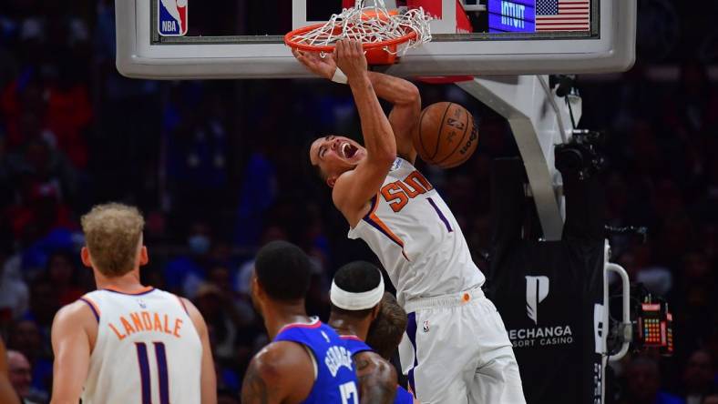 Oct 23, 2022; Los Angeles, California, USA; Phoenix Suns guard Devin Booker (1) dunks for a basket against the Los Angeles Clippers during the second half at Crypto.com Arena. Mandatory Credit: Gary A. Vasquez-USA TODAY Sports