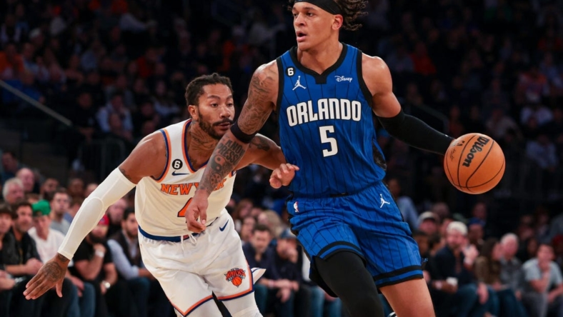 Oct 24, 2022; New York, New York, USA; Orlando Magic forward Paolo Banchero (5) dribbles as New York Knicks guard Derrick Rose (4) defends during the first half at Madison Square Garden. Mandatory Credit: Vincent Carchietta-USA TODAY Sports