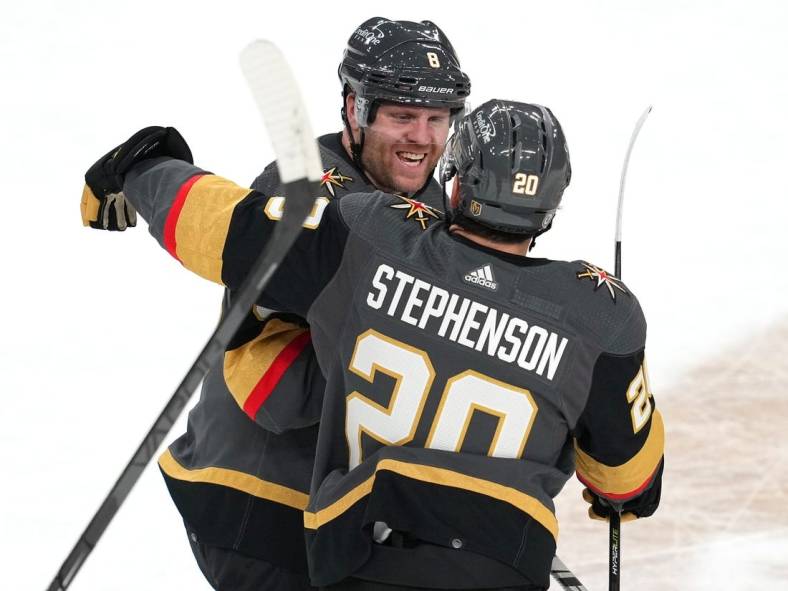 Oct 24, 2022; Las Vegas, Nevada, USA; Vegas Golden Knights center Chandler Stephenson (20) celebrates with Vegas Golden Knights center Phil Kessel (8) after the Golden Knights defeated the Toronto Maple Leafs 3-1 at T-Mobile Arena. With his 989th consecutive regular-season game under his belt, Phil Kessel has officially tied the National Hockey League's "Ironman" streak. Mandatory Credit: Stephen R. Sylvanie-USA TODAY Sports