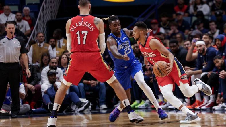Oct 25, 2022; New Orleans, Louisiana, USA; New Orleans Pelicans guard CJ McCollum (3) dribbles against Dallas Mavericks forward Reggie Bullock (25) during the first half at Smoothie King Center. Mandatory Credit: Stephen Lew-USA TODAY Sports