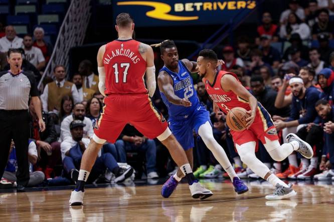 Oct 25, 2022; New Orleans, Louisiana, USA; New Orleans Pelicans guard CJ McCollum (3) dribbles against Dallas Mavericks forward Reggie Bullock (25) during the first half at Smoothie King Center. Mandatory Credit: Stephen Lew-USA TODAY Sports
