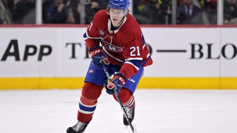 Oct 25, 2022; Montreal, Quebec, CAN; Montreal Canadiens defenseman Kaiden Guhle (21) plays the puck during the second period of the game against the Minnesota Wild at the Bell Centre. Mandatory Credit: Eric Bolte-USA TODAY Sports