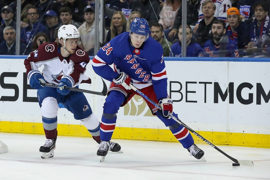 Oct 25, 2022; New York, New York, USA; New York Rangers right wing Kaapo Kakko (24) moves the puck past Colorado Avalanche defenseman Bowen Byram (4) during the first period at Madison Square Garden. Mandatory Credit: Tom Horak-USA TODAY Sports