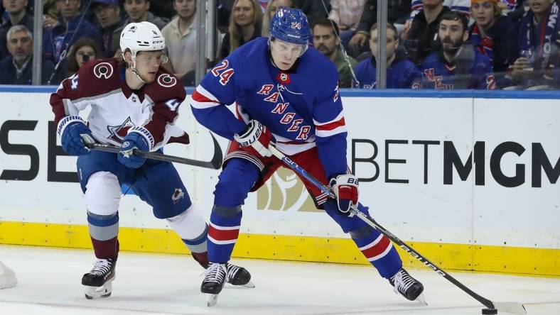 Oct 25, 2022; New York, New York, USA; New York Rangers right wing Kaapo Kakko (24) moves the puck past Colorado Avalanche defenseman Bowen Byram (4) during the first period at Madison Square Garden. Mandatory Credit: Tom Horak-USA TODAY Sports