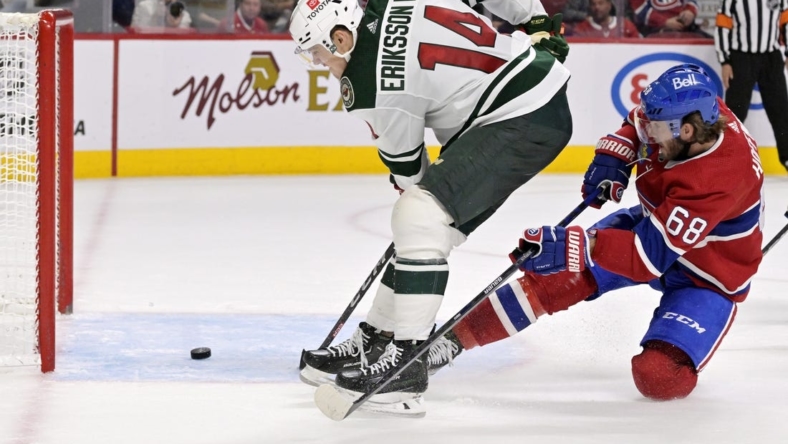 Oct 25, 2022; Montreal, Quebec, CAN; Minnesota Wild forward Joel Eriksson Ek (14) scores a goal and Montreal Canadiens forward Mike Hoffman (68) defends during the third period at the Bell Centre. Mandatory Credit: Eric Bolte-USA TODAY Sports