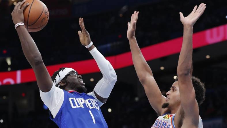 Oct 25, 2022; Oklahoma City, Oklahoma, USA; LA Clippers guard Reggie Jackson (1) shoots as Oklahoma City Thunder forward Jeremiah Robinson-Earl (50) defends the shot during the second half at Paycom Center. Oklahoma City won 108-94. Mandatory Credit: Alonzo Adams-USA TODAY Sports