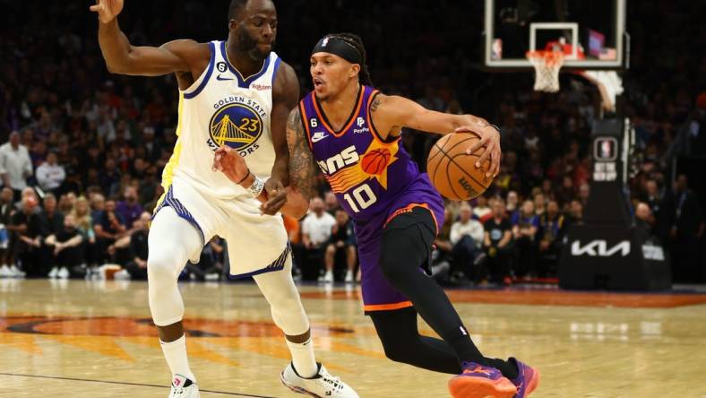 Oct 25, 2022; Phoenix, Arizona, USA; Phoenix Suns guard Damion Lee (10) moves the ball against Golden State Warriors forward Draymond Green (23) in the first half at Footprint Center. Mandatory Credit: Mark J. Rebilas-USA TODAY Sports