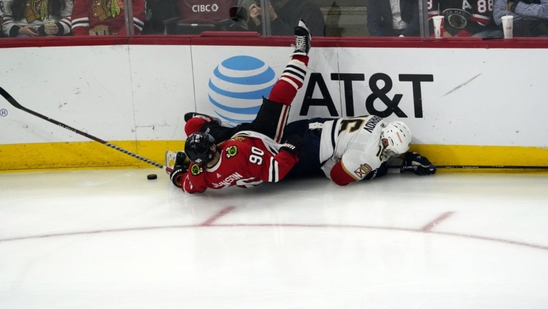 Oct 25, 2022; Chicago, Illinois, USA; Chicago Blackhawks center Tyler Johnson (90) and Florida Panthers center Aleksander Barkov (16) go for the puck during the third period  at United Center. Mandatory Credit: David Banks-USA TODAY Sports
