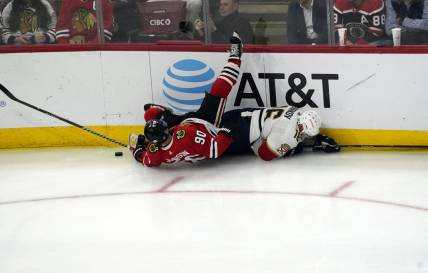 Oct 25, 2022; Chicago, Illinois, USA; Chicago Blackhawks center Tyler Johnson (90) and Florida Panthers center Aleksander Barkov (16) go for the puck during the third period  at United Center. Mandatory Credit: David Banks-USA TODAY Sports