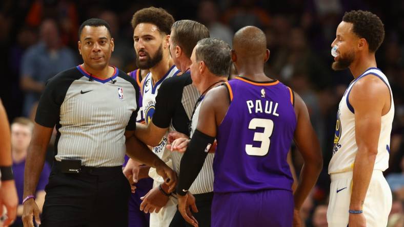 Oct 25, 2022; Phoenix, Arizona, USA; Golden State Warriors guard Klay Thompson (second from left) is held back by referees after being ejected from the game against the Phoenix Suns in the second half at Footprint Center. Mandatory Credit: Mark J. Rebilas-USA TODAY Sports