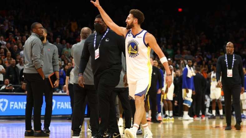 Oct 25, 2022; Phoenix, Arizona, USA; Golden State Warriors guard Klay Thompson waves at the Phoenix Suns bench after being ejected from the game in the second half at Footprint Center. Mandatory Credit: Mark J. Rebilas-USA TODAY Sports