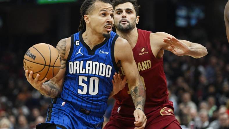 Oct 26, 2022; Cleveland, Ohio, USA; Orlando Magic guard Cole Anthony (50) drives to the basket against Cleveland Cavaliers guard Raul Neto (19) during the first half at Rocket Mortgage FieldHouse. Mandatory Credit: Ken Blaze-USA TODAY Sports