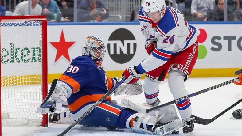 Oct 26, 2022; Elmont, New York, USA; New York Islanders goaltender Ilya Sorokin (30) makes a save against New York Rangers right wing Kaapo Kakko (24) during the first period at UBS Arena. Mandatory Credit: Tom Horak-USA TODAY Sports