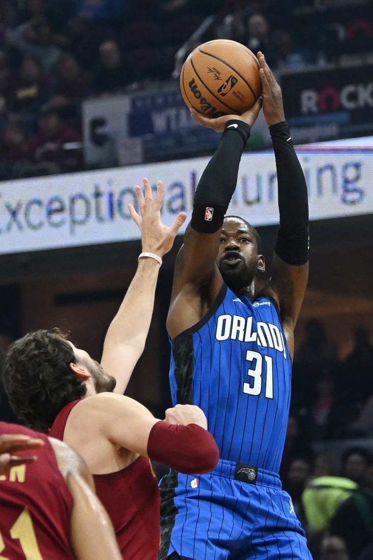 Oct 26, 2022; Cleveland, Ohio, USA; Orlando Magic guard Terrence Ross (31) shoots over the defense of  Cleveland Cavaliers forward Cedi Osman (16) during the first half at Rocket Mortgage FieldHouse. Mandatory Credit: Ken Blaze-USA TODAY Sports