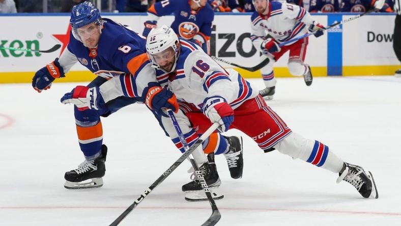 Oct 26, 2022; Elmont, New York, USA; New York Rangers center Vincent Trocheck (16) attempts to move the puck past New York Islanders defenseman Ryan Pulock (6) during the first period at UBS Arena. Mandatory Credit: Tom Horak-USA TODAY Sports
