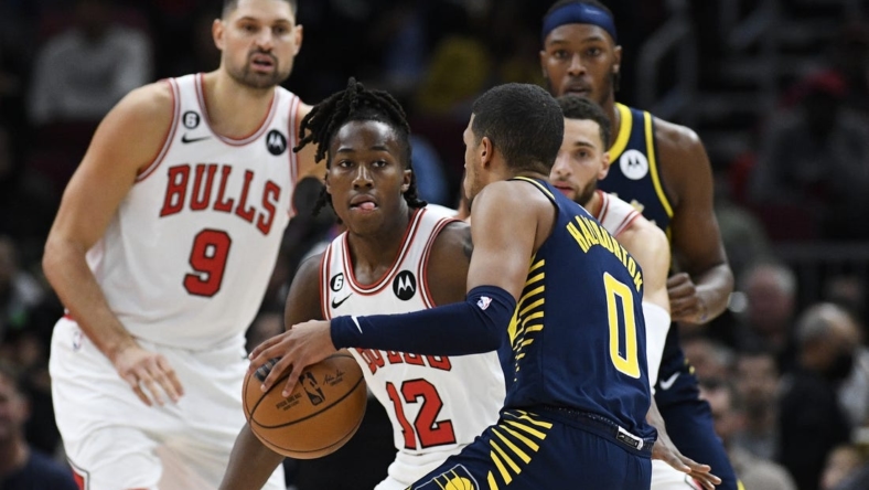 Oct 26, 2022; Chicago, Illinois, USA; Chicago Bulls guard Ayo Dosunmu (12) defends Indiana Pacers guard Tyrese Haliburton (0) during the first half at the  United Center. Mandatory Credit: Matt Marton-USA TODAY Sports