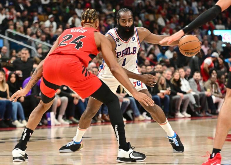Oct 26, 2022; Toronto, Ontario, CAN; Philadelphia 76ers guard James Harden (1) dribbles the ball in front of Toronto Raptors center Khem Birch (24) in the first half at Scotiabank Arena. Mandatory Credit: Dan Hamilton-USA TODAY Sports